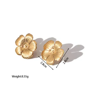 Detail view of gold floral stud earrings with engraved petals, 2.8cm size with 8.55g weight