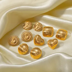 Vintage 18k gold plated heart and stripe embossed earrings on champagne silk background