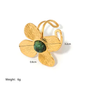 18k gold plated stainless steel flower ring with centered green stone and open band