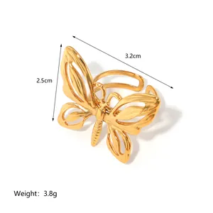 Adjustable 18k gold butterfly ring featuring green emerald stone and hollow design