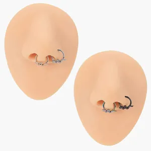 Detailed view of snake-shaped 316L stainless steel nose rings in four metallic finishes