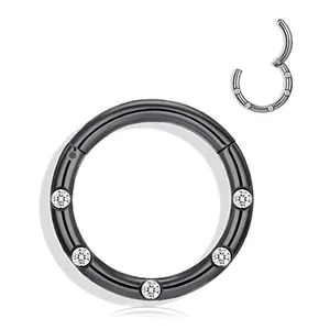 Macro detail of black stainless steel hinged nose ring with five inlaid sparkling zircons