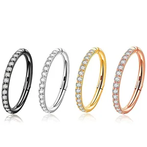 Detailed view of four multi-color 316L stainless steel clicker rings with zircon inlay