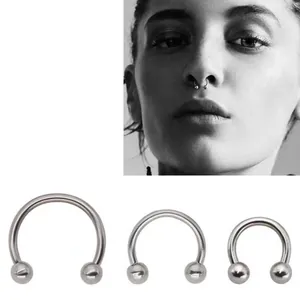 Polished stainless steel septum rings in three sizes with a model wearing a horseshoe ring