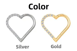 Detail view of heart-shaped 316L stainless steel clickers in silver and gold with diamonds