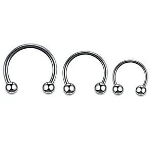 Three sizes of polished stainless steel horseshoe rings with ball ends for piercings
