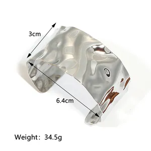 Polished wavy 18K gold plated stainless steel wide cuff bracelet with irregular texture