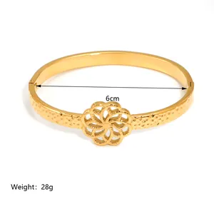 Detail of 18K gold-plated bangle showing 6cm inner diameter and hammered metal texture