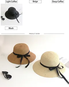 Detail view of woven straw sun hats featuring elegant black ribbons in multiple neutral colors