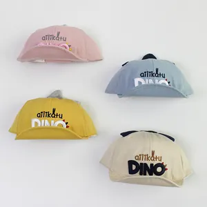 Casquettes de baseball dinosaure pour bébé en rose, bleu, jaune et beige à bord souple