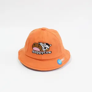 Orange cotton kids bucket hat featuring a cute cartoon cow embroidery and a blue logo patch