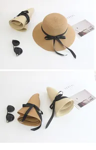 Detail of foldable woven straw hat with black ribbon bow and texture for travel