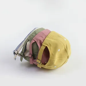 Detail view of cotton baseball caps with adjustable metal buckles in five various colors