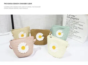 Detail of multi-colored hand-woven daisy purses for girls with zipper closure
