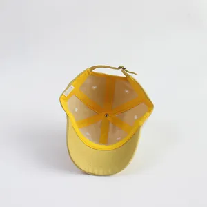 Detail view of cotton baseball cap interior with adjustable metal buckle and breathable eyelets