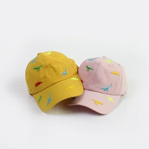 Kids cotton baseball caps featuring dinosaur embroidery in yellow and pink colors