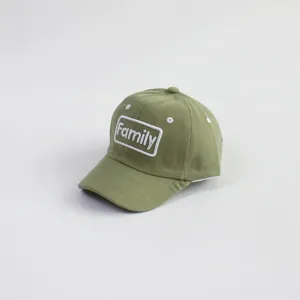 Close-up of olive green kids baseball cap featuring white Family embroidery on cotton
