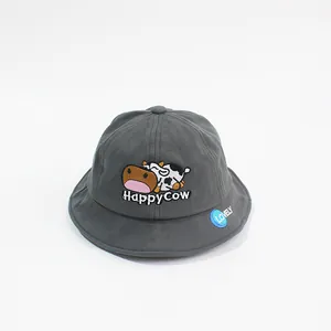 Close-up of cute cartoon cow embroidery and Happy Cow text on dark gray bucket hat