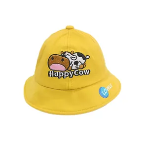 Kids yellow cotton sun hat featuring cute cartoon cow embroidery and Happy Cow text