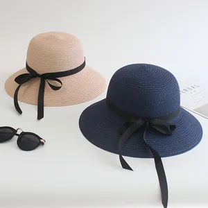 Women's summer straw sun hats in beige and navy blue with elegant black ribbon bow