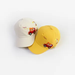 Detailed view of kids cotton baseball caps with bear and car cartoon embroidery