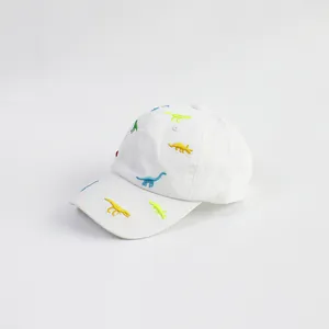 Detail of colorful dinosaur embroidery on a breathable white cotton kids baseball cap