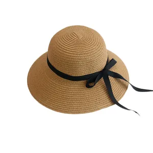 Women's woven straw sun hat with black ribbon bow and wide brim for summer UV protection