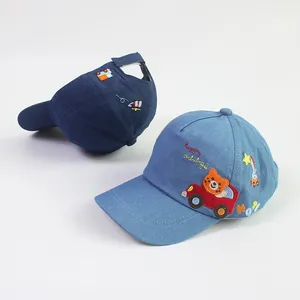Close-up of blue denim kids baseball caps with bear driving car cartoon embroidery