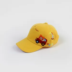 Detail of baby baseball cap featuring bear driving car embroidery and happy text