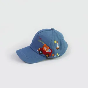 Detail of blue denim baby baseball cap with cartoon tiger driving car embroidery