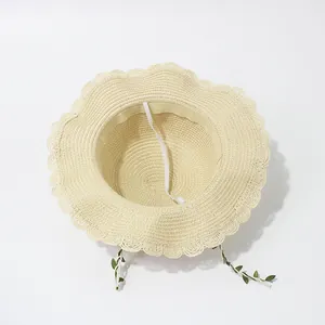 Kids wide brim straw sun hat with wavy edges and green leaf ribbon decoration