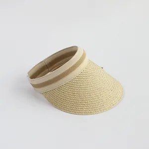 Close-up of beige woven straw sun hat showing striped brim edge and texture details