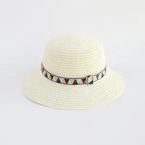 Detailed close-up showing the fine straw weave and geometric patterned strap of the sun hat
