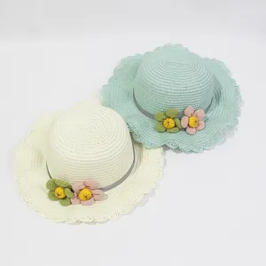 Detail of straw sun hats with wavy lace edges and floral ribbon for girls' beach trips