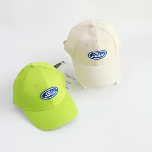 Kids cotton baseball caps in neon green and beige with Blue embroidery and sun protection