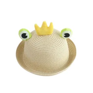 Kids beige straw sun hat with cute green frog eyes and a yellow crown decoration