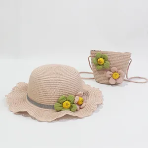 Pink straw sun hat and matching mini crossbody bag set with decorative 3D floral accents