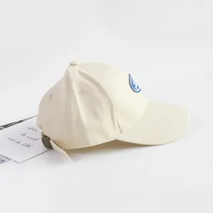 Detail of children cotton baseball cap showing side embroidery patch and metal buckle