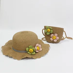 Detail of children's straw hat and matching bag with decorative fabric flowers