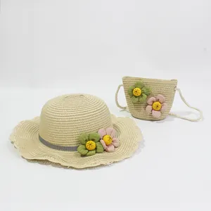Detail of girls straw sun hat and matching crossbody bag with floral ornaments