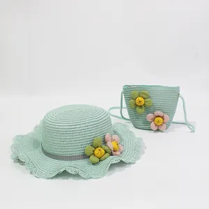 Detail of mint green straw sun hat and matching floral crossbody bag for girls