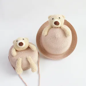 Kids pink straw sun hat and matching crossbody bag featuring a cute plush bear design