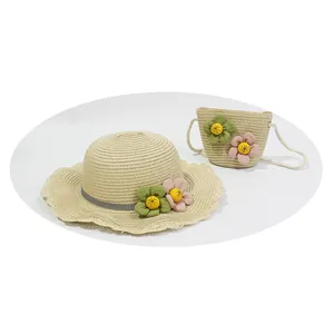 Kids woven straw sun hat and matching crossbody bag with floral accents and wavy brim