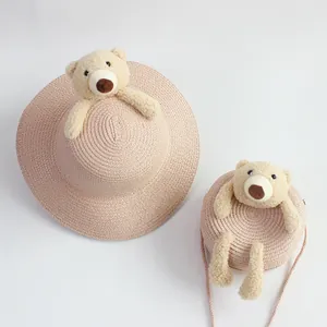 Pink straw sun hat and matching crossbody bag set with cute plush bear decorations