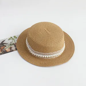 Détail du chapeau de paille avec dentelle blanche élégante et ornements en perles