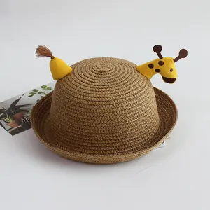 Detail of children's straw hat with cute 3D giraffe design and woven texture