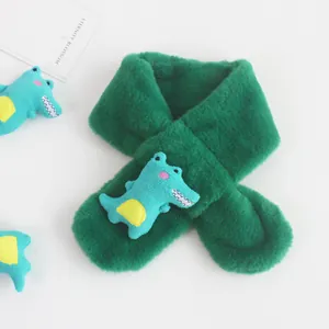 Detail view of dark green plush scarf with cute cartoon dinosaur and crossover design