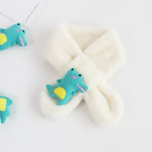 Close-up of cream faux fur kids scarf featuring a cute green crocodile plush toy