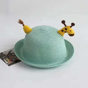 Detailed close-up of mint green straw hat with cute 3D fabric giraffe and woven texture