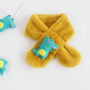 Detail of plush yellow kids scarf with a cute green crocodile plush and cross-pull hole